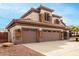 Two-story house with three-car garage, stone accents, and landscaped yard at 1451 E Ivanhoe St, Gilbert, AZ 85295