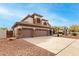 Two-story house with three-car garage, stone accents, and landscaped yard at 1451 E Ivanhoe St, Gilbert, AZ 85295