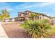 Two-story house with three-car garage, stone accents, and landscaped yard at 1451 E Ivanhoe St, Gilbert, AZ 85295