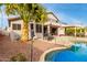 Inviting backyard oasis with a sparkling pool, patio, and outdoor kitchen at 1451 E Ivanhoe St, Gilbert, AZ 85295