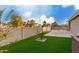 Landscaped backyard with artificial turf and block wall fencing at 15207 W Windward Ave, Goodyear, AZ 85395