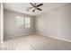 Spacious bedroom with wood-look floors and ceiling fan at 15207 W Windward Ave, Goodyear, AZ 85395