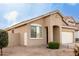 Tan one-story house with a two-car garage and nicely landscaped yard at 15207 W Windward Ave, Goodyear, AZ 85395