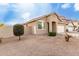 One story house with tan exterior, two-car garage, and desert landscaping at 15207 W Windward Ave, Goodyear, AZ 85395