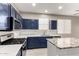 Modern kitchen with navy cabinets and granite countertops at 15207 W Windward Ave, Goodyear, AZ 85395