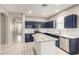 Modern kitchen with granite countertops and navy blue cabinets at 15207 W Windward Ave, Goodyear, AZ 85395