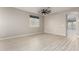 Spacious living room with light wood flooring and ceiling fan at 15207 W Windward Ave, Goodyear, AZ 85395