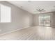 Living room with sliding door to backyard and wood-look floors at 15207 W Windward Ave, Goodyear, AZ 85395