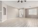 Bright living room featuring wood-look floors and recessed niche at 15207 W Windward Ave, Goodyear, AZ 85395