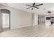 Bright living room with wood-look floors and ceiling fan at 15207 W Windward Ave, Goodyear, AZ 85395