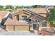 Aerial perspective of a two-story house showcasing the tile roof, three-car garage, and front yard at 15727 W Rimrock St, Surprise, AZ 85374
