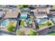 Aerial view of home featuring private backyard pools, solar panels, and lush landscaping at 15727 W Rimrock St, Surprise, AZ 85374