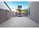 Backyard patio area with basketball hoop and surrounding privacy fence at 15727 W Rimrock St, Surprise, AZ 85374
