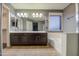 Double vanity bathroom with dark brown cabinets and a large soaking tub at 15727 W Rimrock St, Surprise, AZ 85374