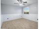 Bedroom featuring tile floors, a ceiling fan, fresh paint, and updated trim work at 15727 W Rimrock St, Surprise, AZ 85374