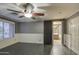 Main bedroom with gray walls, tile floors, and barn door to the bathroom at 15727 W Rimrock St, Surprise, AZ 85374