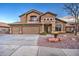 Two-story house with three-car garage and rock landscaping at 15727 W Rimrock St, Surprise, AZ 85374