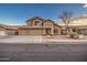 Two-story house with three-car garage and desert landscaping at 15727 W Rimrock St, Surprise, AZ 85374