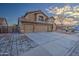 Two-story house with three-car garage and landscaped front yard at 15727 W Rimrock St, Surprise, AZ 85374