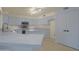 Modern kitchen featuring bright cabinets, an island, stainless steel appliances, and tile flooring at 15727 W Rimrock St, Surprise, AZ 85374