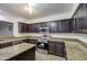 Modern kitchen, granite counters, and stainless steel appliances at 15727 W Rimrock St, Surprise, AZ 85374