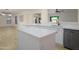 Open kitchen featuring stainless steel appliances, white cabinets, and quartz countertops overlooking the living area at 15727 W Rimrock St, Surprise, AZ 85374