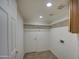 Bright laundry room with built-in shelving and hanging rod at 15727 W Rimrock St, Surprise, AZ 85374