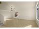 Bright, spacious living room with tiled flooring, chandelier lighting and large windows at 15727 W Rimrock St, Surprise, AZ 85374