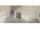 Bright, open-concept living space with staircase, tile floors, and chandelier lighting at 15727 W Rimrock St, Surprise, AZ 85374