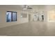 Spacious living room featuring neutral walls, tile flooring, and access to the kitchen at 15727 W Rimrock St, Surprise, AZ 85374