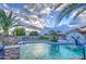 Relaxing backyard oasis featuring a kidney-shaped pool and waterfall at 15727 W Rimrock St, Surprise, AZ 85374