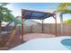 Poolside pergola area featuring lounge space with stone detail at 15727 W Rimrock St, Surprise, AZ 85374