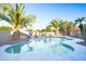 Private pool with waterfall feature and lush landscaping including mature palm trees at 15727 W Rimrock St, Surprise, AZ 85374
