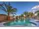 Sparkling pool with waterfall and palm trees at 15727 W Rimrock St, Surprise, AZ 85374