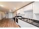 View of the updated kitchen with white cabinets, granite countertops, and appliances at 16230 N 35Th Way, Phoenix, AZ 85032