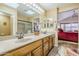 Double vanity bathroom with a large mirror and a shower at 17065 N Silver Path, Surprise, AZ 85374