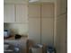 Laundry room with wooden cabinets and storage at 17407 N Country Club N Dr, Sun City, AZ 85373