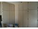 Laundry room with wooden cabinets and storage at 17407 N Country Club N Dr, Sun City, AZ 85373