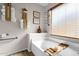 Relaxing bathroom with a bathtub, wooden tray, and neutral color scheme at 17600 N 64Th Dr, Glendale, AZ 85308