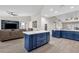 Kitchen with island, blue cabinetry, and stainless steel appliances at 17600 N 64Th Dr, Glendale, AZ 85308