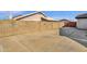 Large side yard with a concrete pad and tall block wall for privacy at 17600 N 64Th Dr, Glendale, AZ 85308