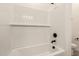Immaculate white tiled shower and tub combo with modern fixtures at 18219 W Hess St, Goodyear, AZ 85338