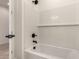 This bright bathtub features a subway tile surround and black fixtures at 18219 W Hess St, Goodyear, AZ 85338