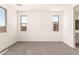Comfortable bedroom with two windows and neutral walls offering a calming retreat at 18219 W Hess St, Goodyear, AZ 85338