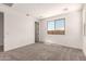This bedroom features plush carpet, a window for natural light, and neutral paint at 18219 W Hess St, Goodyear, AZ 85338