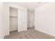 Clean bedroom featuring a sliding closet, carpeted floors, and ample natural light at 18219 W Hess St, Goodyear, AZ 85338