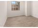 Bright bedroom featuring wood-look floors and a window with outside view at 18219 W Hess St, Goodyear, AZ 85338