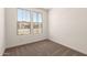 This carpeted bedroom has a window allowing natural light at 18219 W Hess St, Goodyear, AZ 85338