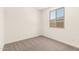Cozy bedroom with plush carpet and a bright window overlooking the exterior at 18219 W Hess St, Goodyear, AZ 85338