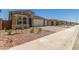 Charming single-Gathering home with a manicured lawn and a paved driveway leading to an attached garage at 18219 W Hess St, Goodyear, AZ 85338